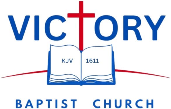 Logo of Victory Baptist Church with a cross and Bible.